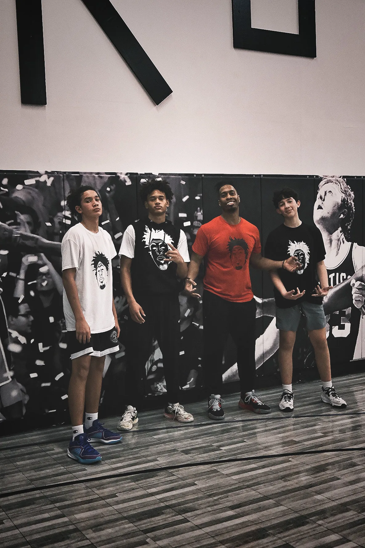 Ben Allen with three young players posing together at Benjamin Buckets Training