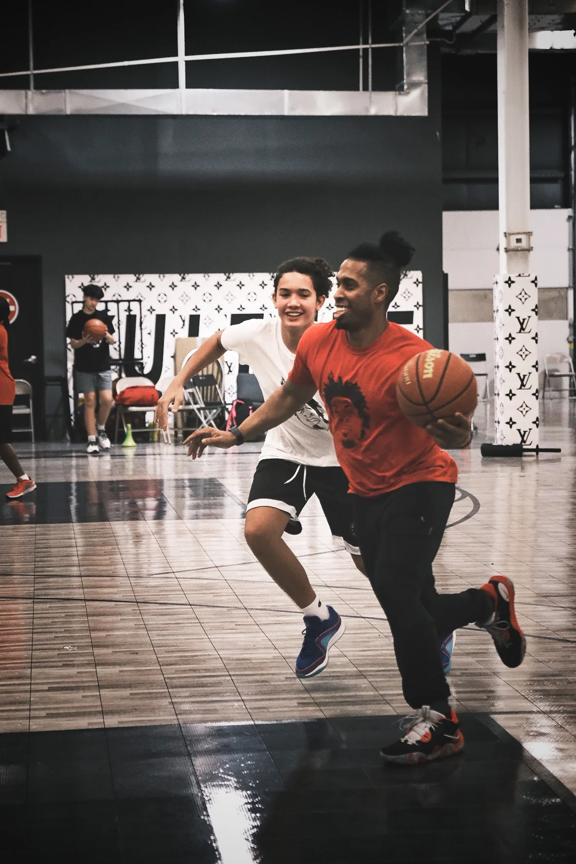 Ben Allen driving full speed past a young player during training