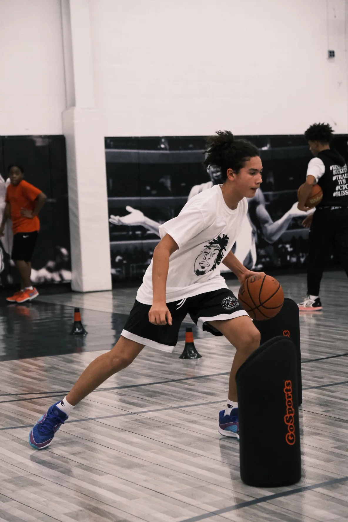 Young player dribbling around pop-up defender at Benjamin Buckets Training