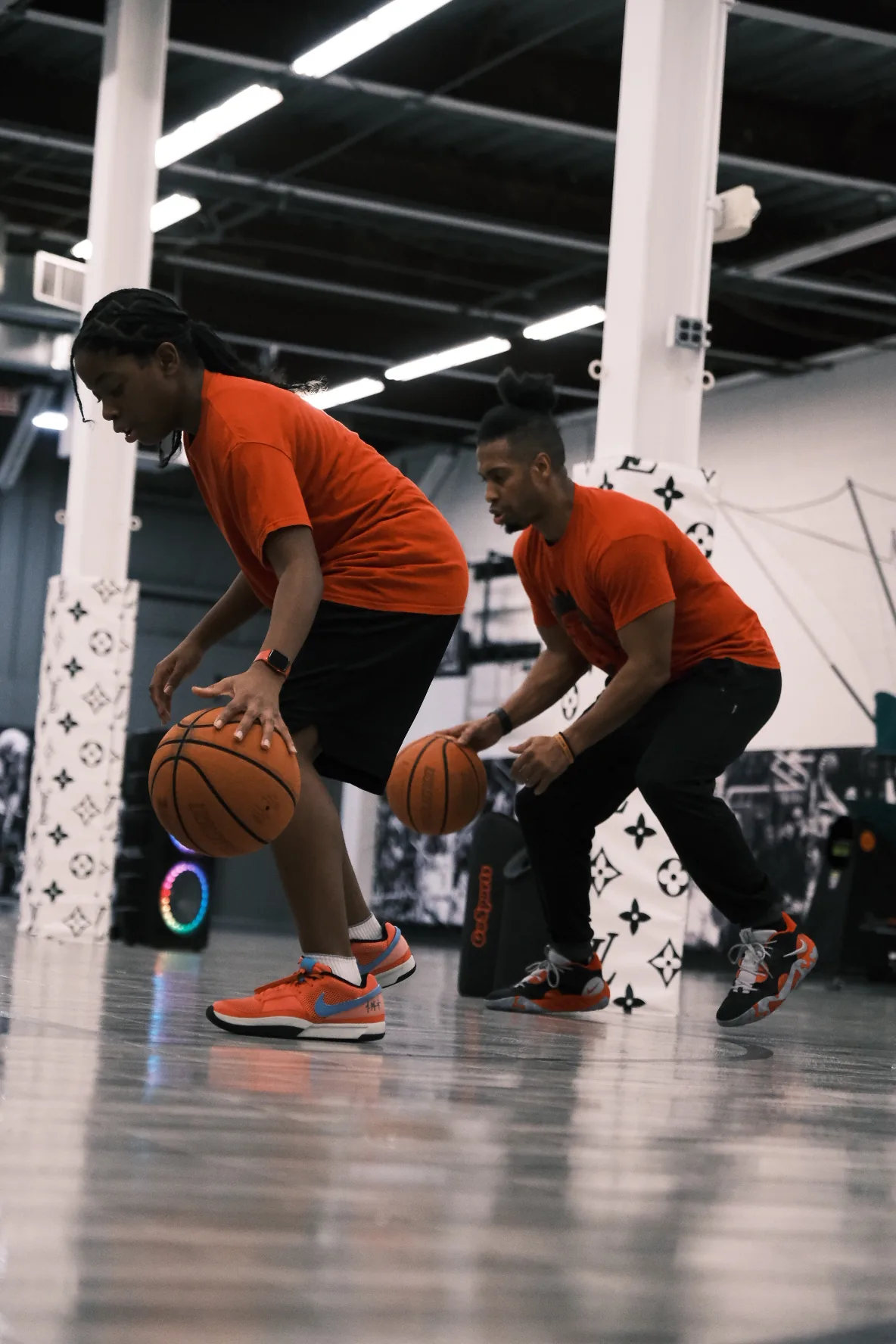 Ben Allen and a young player performing dual-ball dribble drill at Benjamin Buckets Training